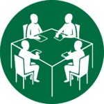 Four people working at a table icon in green