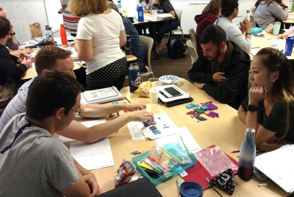 Four teachers working together with tiles