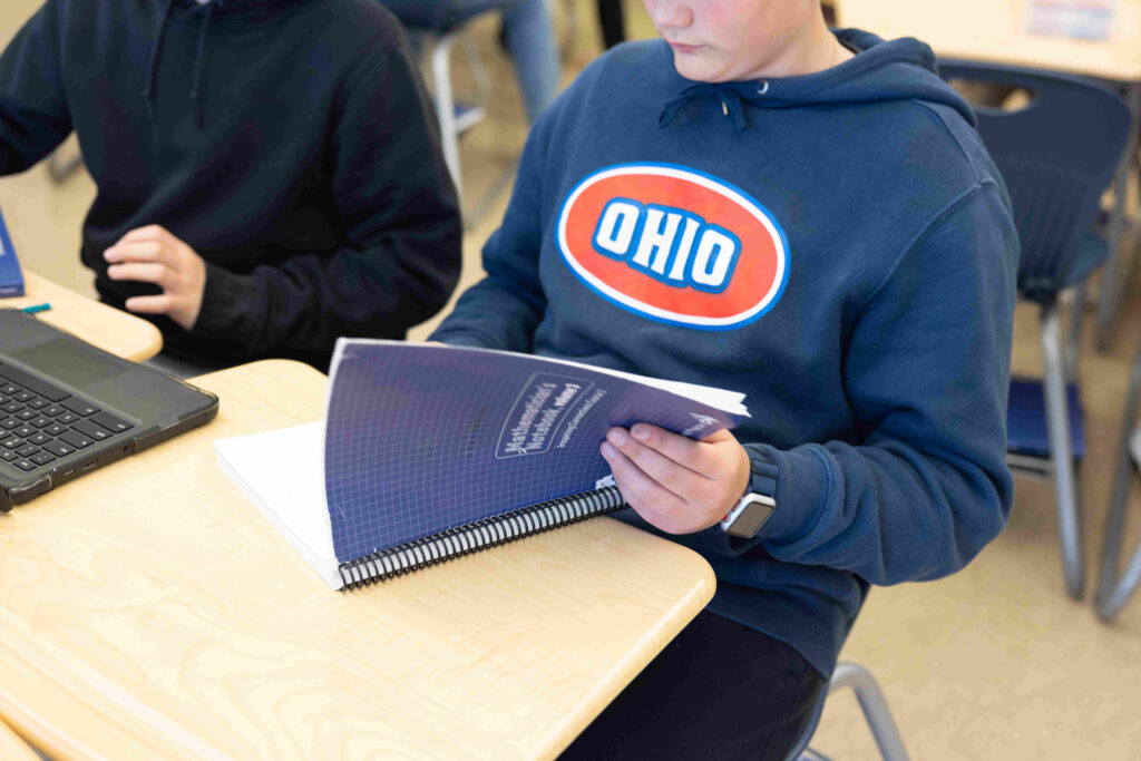 student flipping through notebook