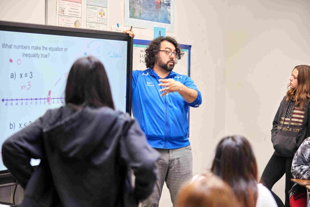 teacher presenting in front of classroom