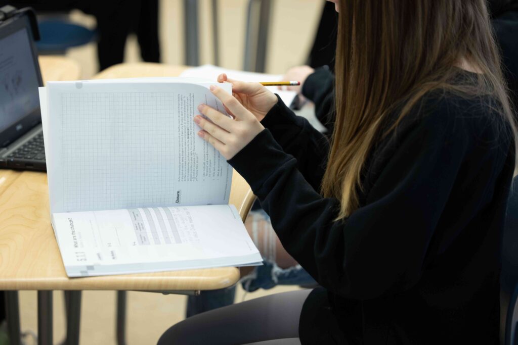 student writing in notebook